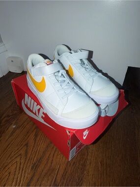 Nike White Low-Top Sneakers with Yellow Swoosh